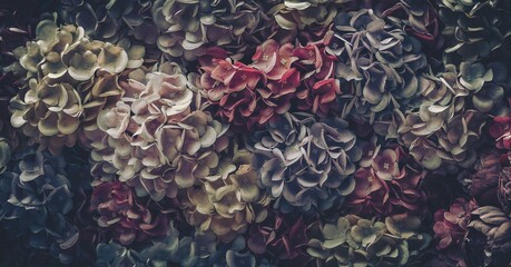A close-up of vintage artificial flowers with faded petals and a muted color palette.