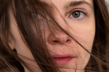 Portrait of young woman with windswept hair