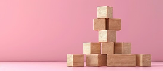 A symbolic representation of a marketing budget message displayed on wooden blocks against a pink backdrop in a copy space image