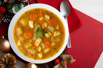 Squid stew with potatoes and vegetables. Top view table with Christmas decoration.