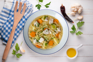 Fish, noodle and vegetable soup. Top view table with  decoration.