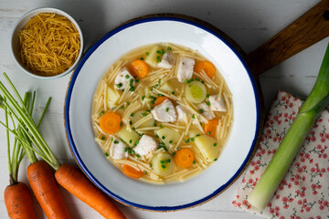 Fish, noodle and vegetable soup. Top view table with  decoration.