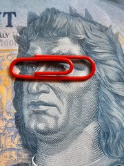 1000 forint banknote with one red paper clip like a glasses.