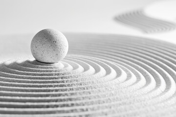 Japanese zen garden with stone in textured white sand