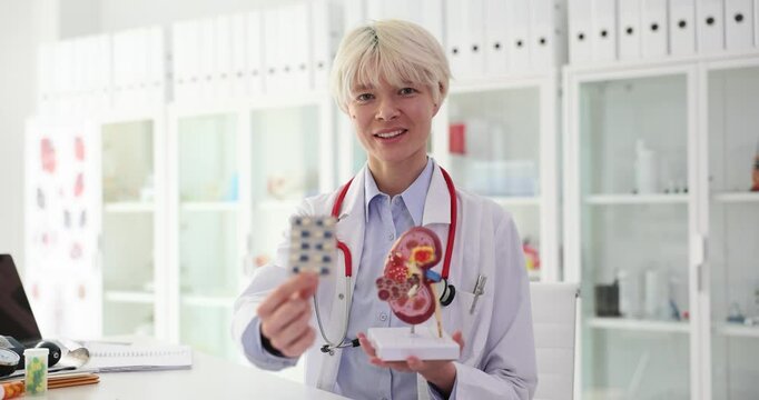 Doctor is holding medical pills and kidney anatomy. Concept of healthcare and early treatment of kidney disease