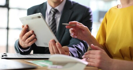 Colleagues partners talking using digital tablet are sitting at office table. Technical device and corporate technology business applications - Powered by Adobe
