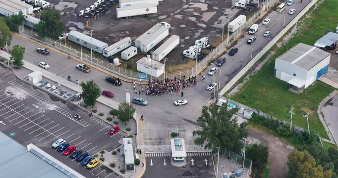 Funeral procession heading towards the town of Axotl&aacute;n, Cuautitl&aacute;n Izcalli, on the outskirts of Mexico City passing by the main entrance of an industrial park, bordering the rural area of the locality