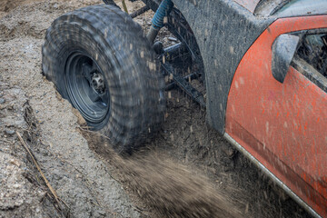 4WD car Off-road wheel spinning, 4WD off road motion the wheel tires and off-road that goes in the mud, 4WD spinning wheel tire in mud terrain.