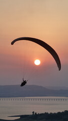 paraglider silhouette at sunset