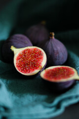 Close up of fresh ripe fig fruits in green fabric with dark shadows