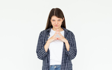 I have great evil plan. Confident and tricky woman in blue shirt, holding fingers together and...