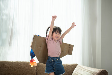 Happy Asian little child girl playing in an astronaut costume © surachetkhamsuk