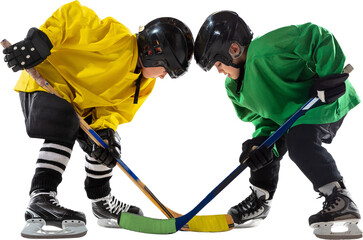 Fototapeta premium Two young hockey players, boys one in yellow and green uniform, face off with sticks hover near puck, ready for action isolated on transparent background. Concept of sport, childhood, active lifestyle
