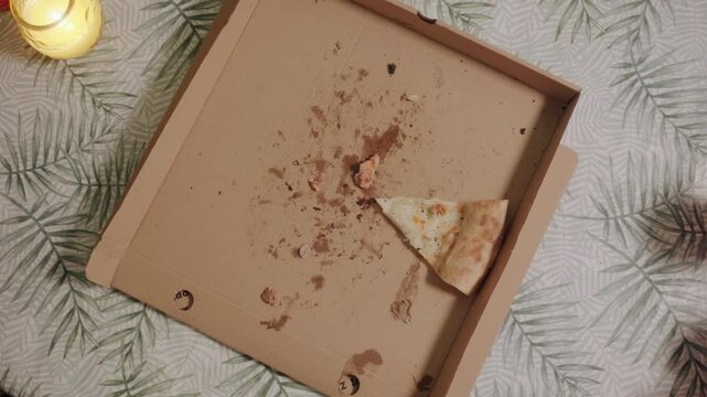 Hands Grabbing Slices of Pizza from Nearly Empty Box