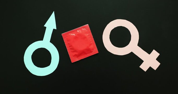 Female and male icon with condoms. Erotic concept