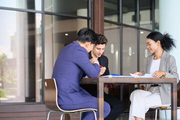 Obraz premium Group of diverse business team are working together on desk outside the office for strategic plan.