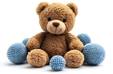 a teddy bear sitting next to blue balls