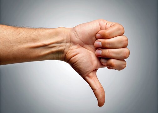 A thumbs down gesture, palm facing outwards, fingers curled in, expresses disapproval, rejection, or dislike, conveying