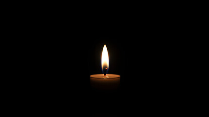 A single candle burns brightly in the darkness, illuminating the surroundings with a warm, flickering glow