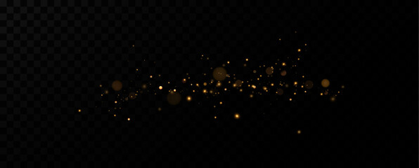 Golden dust light.The dust sparks and golden stars shine with special light.Luxurious background of golden particles.Christmas glowing dust.	