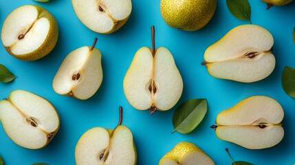 Freshly sliced pears with green leaves arranged artistically on a white background