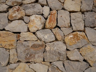 Stone wall as a background or texture. Part of a stone wall.
