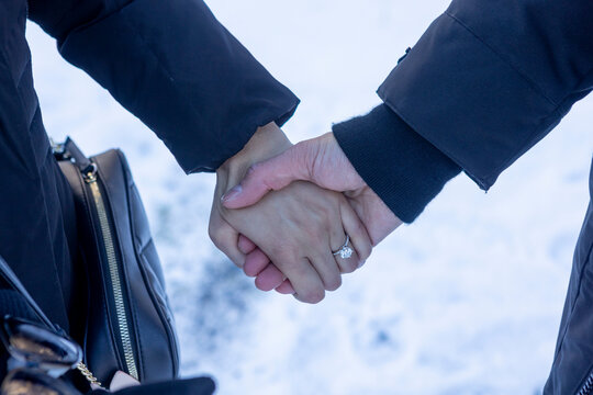Couple celebrating engagement in snowy setting