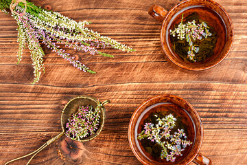 A cup of heather tea on a table.