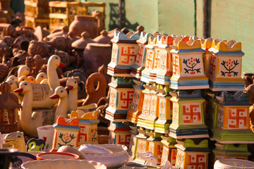 Traditional Indian handmade Items of Earthenware Or Ceramic at a Vendor Stall,decorative  Sculpture  Made with Earthen Mud, handcrafted traditional clay decoration toy in indian market
