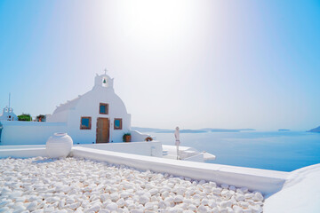 beautiful details of Santorini island - typical house with white walls and blue Aegan sea Greece