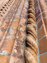 Background of red columns in different geometric shapes as wall decoration.