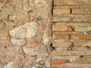 Distressed wall surface. Grunge brown and orange stone wall