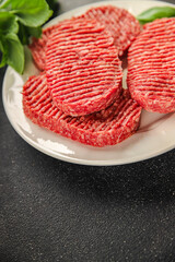 Raw cutlet fresh ground meat beef burger, pork, chicken, turkey second course dish fresh delicious gourmet food background on the table rustic food top view copy space