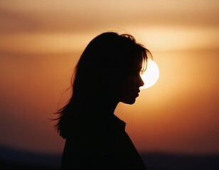 Fototapeta premium female silhouette against the sunset