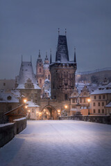 View of  Lesser town tower of Charles Bridge in Prague in the early morning in winter under the...