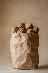 A paper bag filled with walnuts against a beige background.