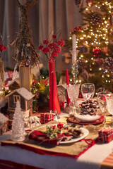 Christmas table setting indoors Christmas decoration in classic red and gold color scheme