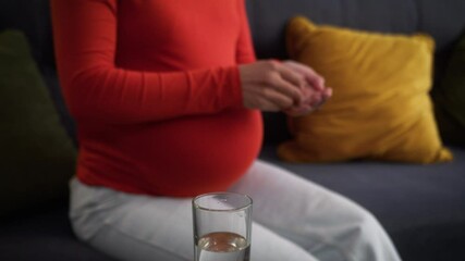 Happy smiling mother pregnant woman African American healthy girl female home pregnancy problem big belly tummy child care drinking remedy pill medication dose vitamin supplement water health medicine