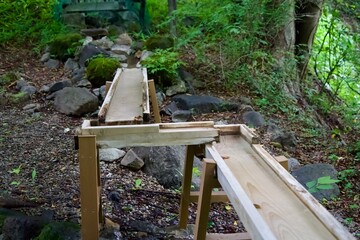 Hot spring water flowing down a wooden path