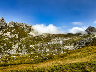 mountain valley under the clouds. lonely mountain hut. lush greenery. mountain landscape. in the clouds. nature background. Log pod Mangartom