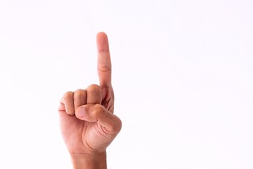 Close up man's hand showing gesture of number​ one on a white background
