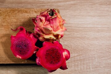 Fresh ripe red Dragon Fruit or pitahaya on a wooden chopping board