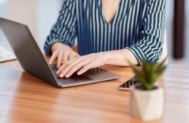 Office Work. Unrecognizable Businesswoman At Laptop Working Typing Business Report Sitting At Workplace Indoor. Selective Focus, Cropped