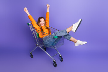 Photo portrait of blonde hair cheerful youngster girl in riding supermarket cart have fun fists up...