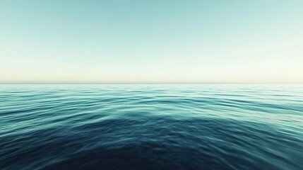 Obraz premium Tranquil ocean horizon with gentle waves under a clear blue sky at sunrise
