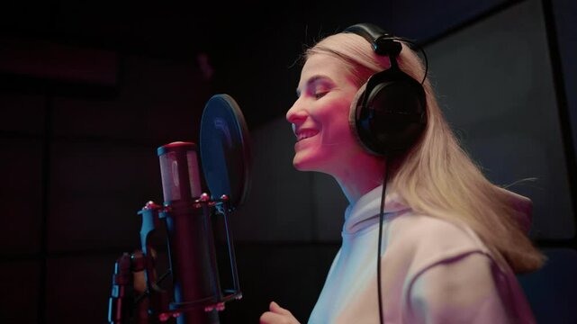 Blonde woman singing song in record studio, portrait of lady with headphones. Future pop star, hobby and professional occupation, vocal talents, girl enjoying beautiful music and favorite song