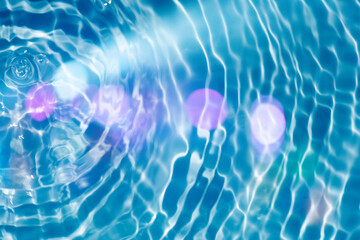 Blue water with ripples on the surface. Defocus blurred transparent blue colored clear calm water...