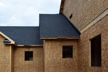 New Home Under Construction with Lumber Framing and Carpentry Builders Craftsman