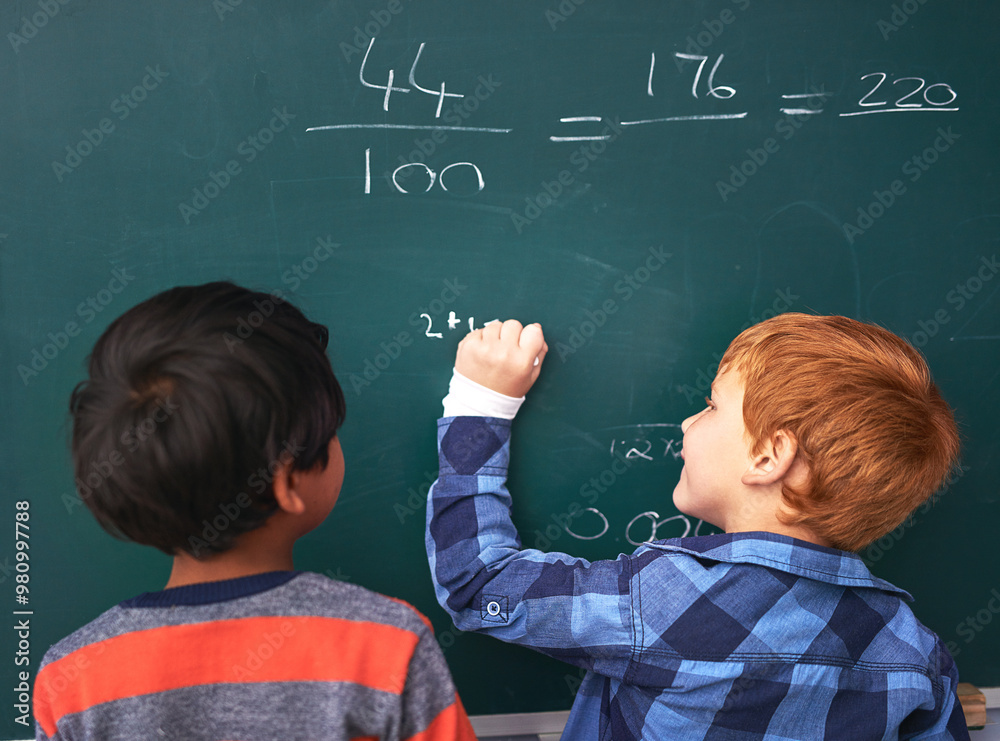 Poster children, writing and mathematics with chalkboard in classroom for education, learning or problem so