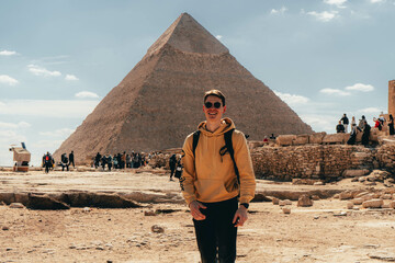 man in front of the great pyramids of Giza